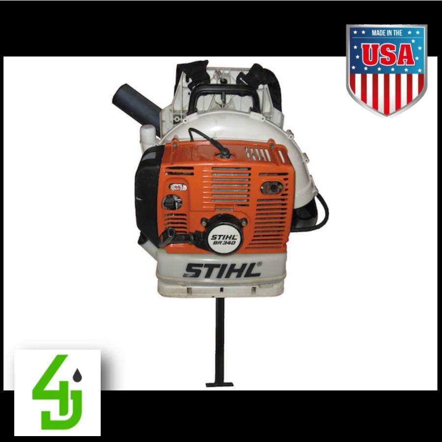 Backpack blower rack mounted on trailer holding Stihl backpack blower securely with black powder-coated steel frame